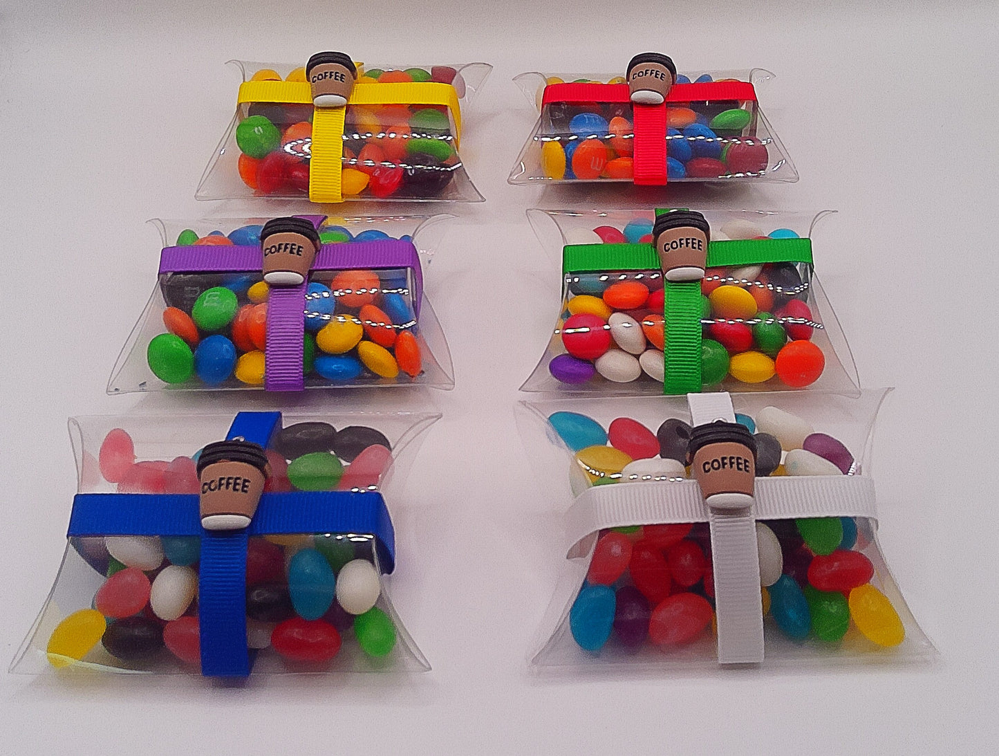 Coffee charm with a clear pillow shaped box filled with lollies