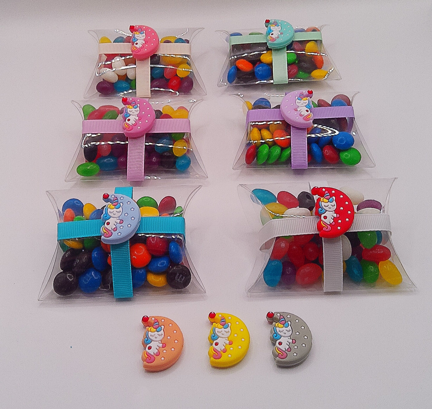 Unicorn asleep on moon charm and clear pillow shaped box filled with lollies