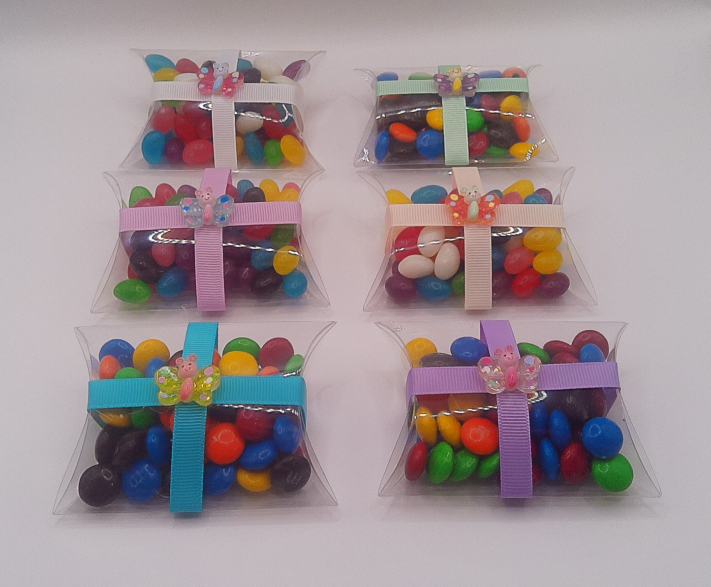 Butterfly charm with clear pillow shaped box filled with lollies