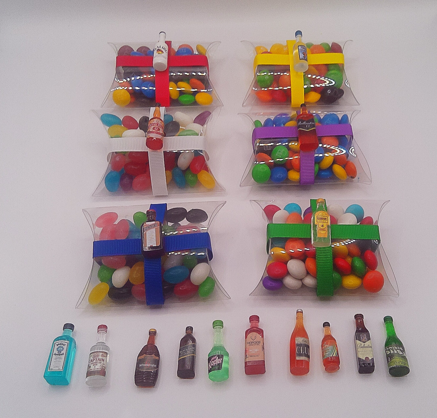 Bottles of alcohol charms with clear pillow shaped box filled with lollies