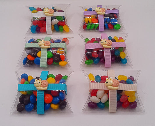 Snail charm and clear pillow shaped box filled with lollies