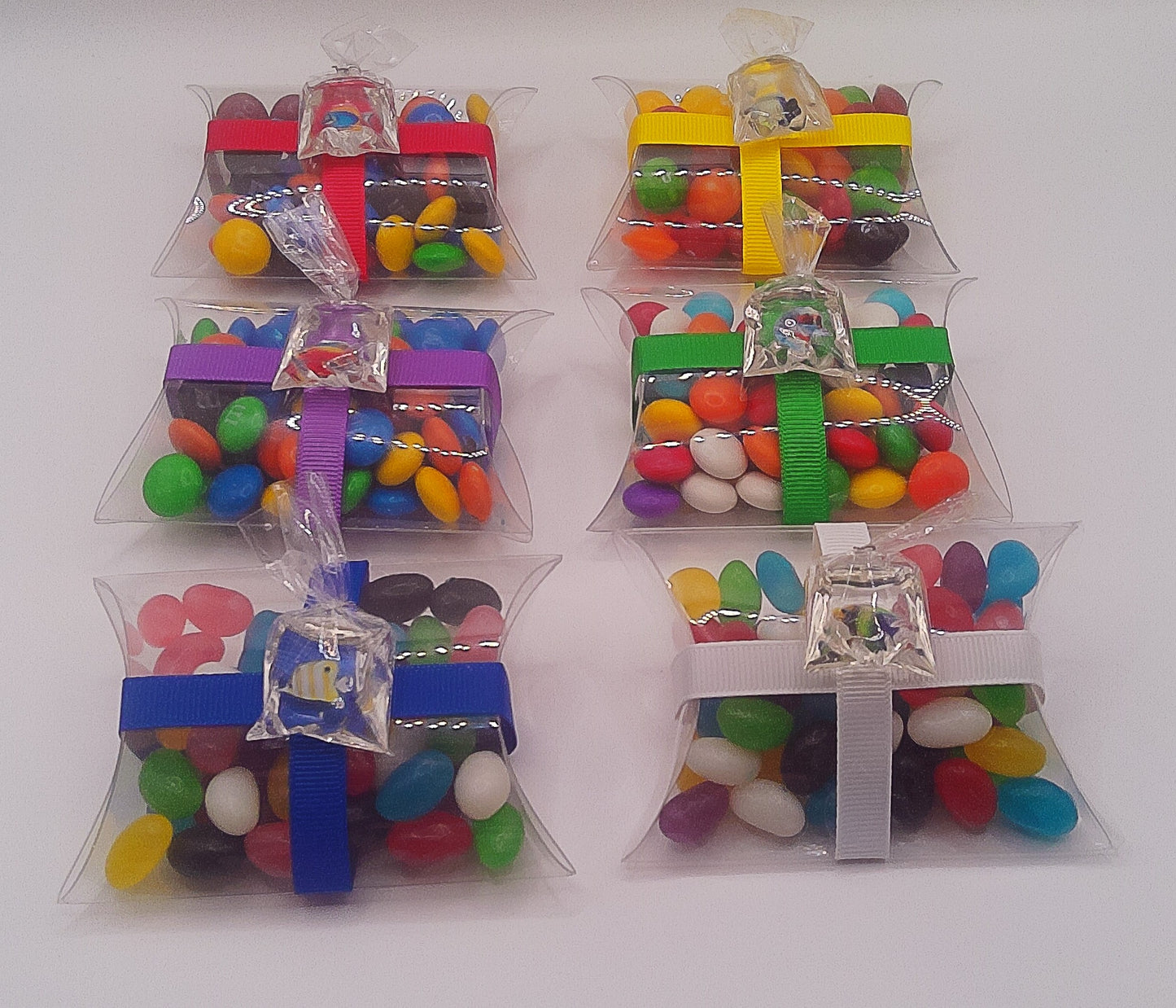 Bag of fish charm with clear pillow shaped box filled with lollies