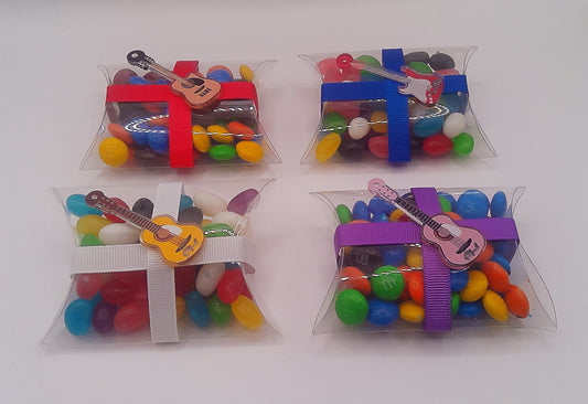 Guitar charm and clear pillow shaped box filled with lollies