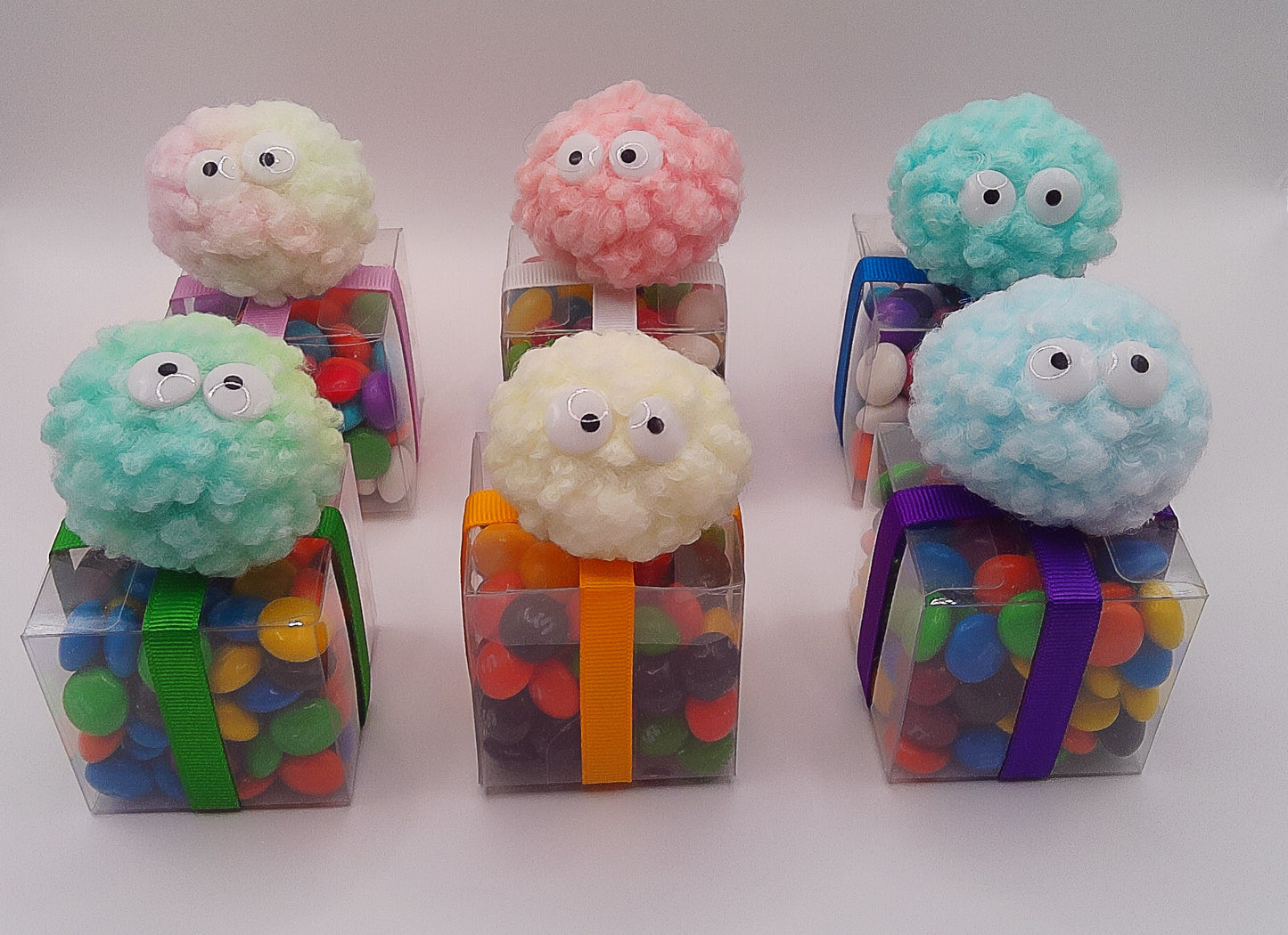 Fluffy creature shoe charms with clear box of lollies